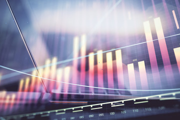 Forex graph hologram on table with computer background. Multi exposure. Concept of financial markets.