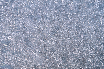 Ice background with natural pattern and tracery. Natural winter texture of frozen water. New Year and Christmas card.