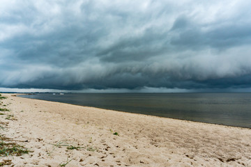 landscape view of thunderstorm coming in at the beach of the baltic sea