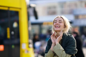 Fototapeten Happy woman in the city with yellow Berlin tramway in the background © gallofilm