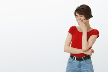 Cheerful carefree tender femenine young european queer woman short pixie haircut enjoy pride month parade party close eyes giggling cover mouth laughing happily having fun white background