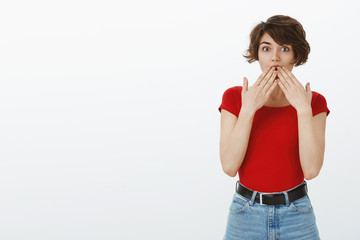 Impressed fascinated good-looking young brunette girl short pixie haircut wondering gasping cover...