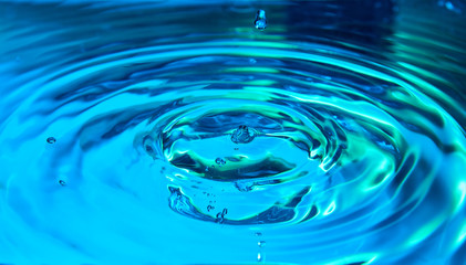 Ripples in color blue water background