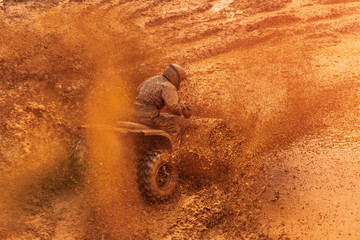 Atv rider on mud road. Exrtime quad ride