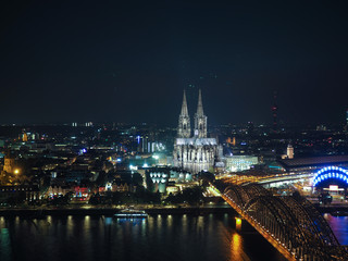 Fototapeta na wymiar Aerial night view of St Peter Cathedral and Hohenzollern Bridge