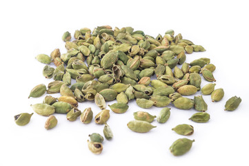 Green cardamom garam masala on white background, macro photography of food herbs 