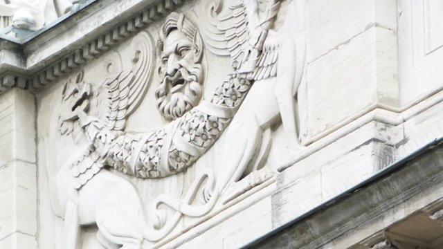 Pan over majestic bas reliefs of Lyon National Opera - Opera de Lyon and Theatre inscription