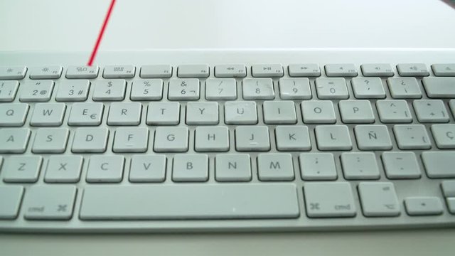 Blasting white keyboard with compressed gas duster spray, Close Up