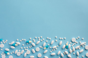 Pills on blue background. Flat lay.