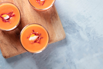 Salmorejo, Spanish cold tomato and bread soup, served in glasses, top shot with copyspace