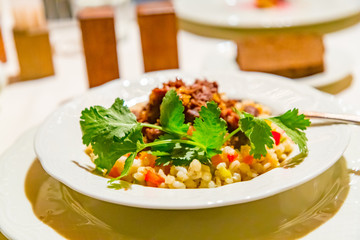 Pearl barley porridge with stew are on the plate.