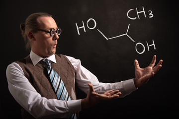 Professor presenting handdrawn chemical formula of propylene glycol -1,2