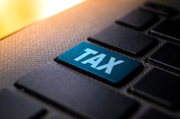 tax keyword on laptop keyboard technology photography