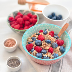 breakfast buckwheat porridge with raspberries and blueberries, good morning concept