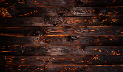 Burnt wooden board, black charcoal wood texture, burned barbecue background