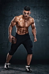Fototapeta na wymiar Strong, Shirtless American Football Player