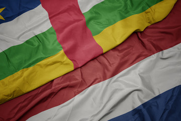 waving colorful flag of netherlands and national flag of central african republic.