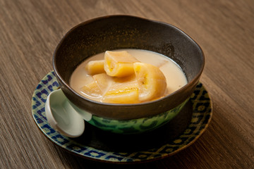 Banana with coconut milk in the bowl.