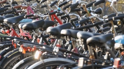 Amsterdam, Netherlands - April 21, 2019: Parking for bicycles. Many different bicycles parked on the street in special parking lots. The problem of bicycle overload in the country