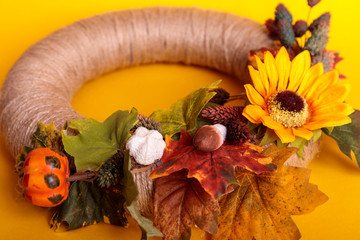 Handmade wreath of small pumpkins and flowers on a vintage door