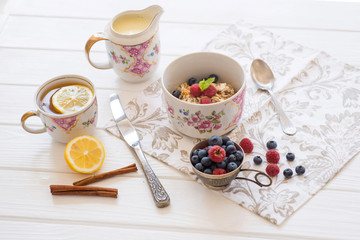 breakfast oatmeal with raspberries and blueberries with tea and honey lemon diet slimming healthy food