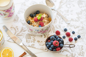 breakfast oatmeal with raspberries and blueberries with tea and honey lemon diet slimming healthy food