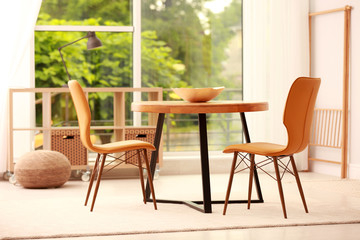 Modern dining room interior with table and chairs