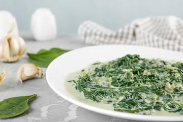 Tasty spinach dip on grey marble table, closeup