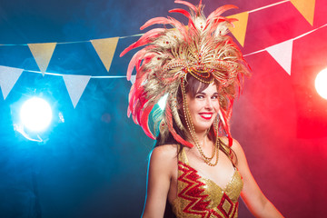 Carnival, belly dance and holiday concept - Beautiful female samba dancer wearing gold costume and smiling