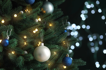 Obraz na płótnie Canvas Beautiful Christmas tree with decor against blurred lights on background