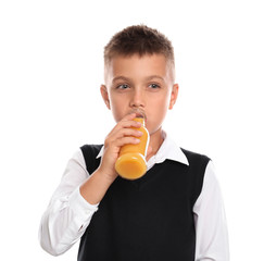 Fototapeta premium Little boy drinking juice on white background