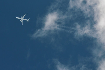 Fototapeta na wymiar Airplane In Blue Sky