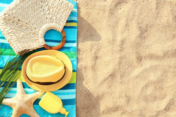 Fototapeta na wymiar Composition with beach accessories on sand, flat lay. Space for text