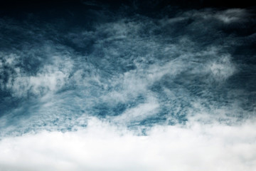 Obraz na płótnie Canvas White fluffy clouds on a dark background