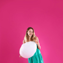 Obraz na płótnie Canvas Happy young woman with cotton candy on pink background