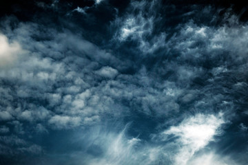 White fluffy clouds on a dark background