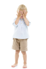 Cute little boy closed his eyes with his palms. The concept of a