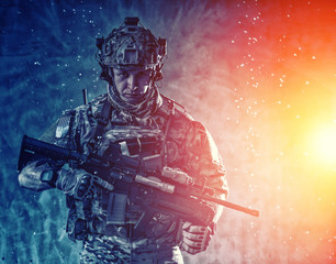 Soldier aiming service rifle under rain at night