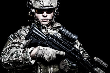 US army soldier with rifle on black background