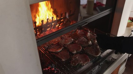 Chops cooked on the grill with fire background, Italy