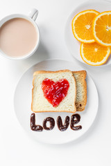 two fresh toast with heart of jam on the white table, orange