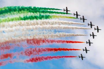 airshow with green white and red smoke