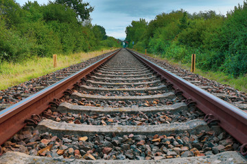 a drone flies in good weather at a very low altitude over railway tracks