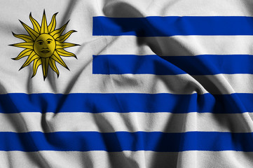 Obraz premium National flag of Uruguay on a waving cotton texture background