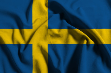 National flag of Sweden on a waving cotton texture background