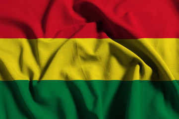 Fototapeta premium National flag of Bolivia on a waving cotton texture background