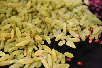 Dried fruit background. Rows of dried dates, apricots,cranberries, pomelos, blueberries, nuts, prunes and figs.