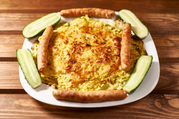oven-fried vegetable pizza with cheese. with cucumber and sausage.