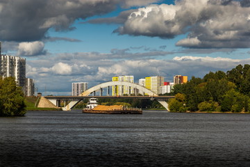 Dry cargo ship on the Moscow Canal river in summer day.