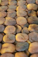 Dried fruit background. Rows of dried dates, apricots,cranberries, pomelos, blueberries, nuts, prunes and figs.